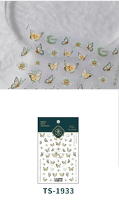 Macro detail of 5D butterfly nail stickers showing floral patterns and TS-1933 model label