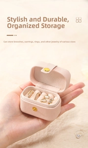 Pink faux leather travel jewelry box with dedicated ring slots and earring compartments