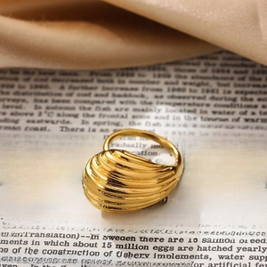 Exaggerated 18K gold chunky croissant ring with a twisted dome design and textured finish