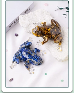Detail view of crystal resin frogs featuring tiger eye and lapis lazuli stones with gold foil
