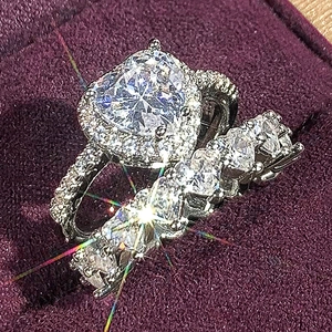 Close-up of heart-shaped zircon bridal set with eternity band in a purple ring box