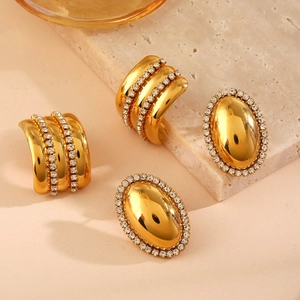 Golden geometric earrings set with sparkling zircon crystals and textured patterns