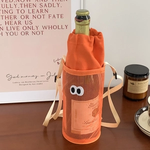 Detail of orange mesh water bottle bag featuring cartoon eyes and adjustable strap