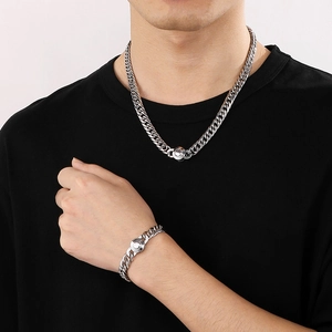 Detail of 9mm stainless steel hip-hop cuban chain necklace and bracelet on male model