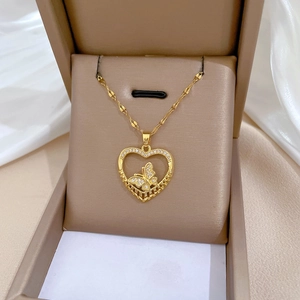 Detail of gold butterfly heart necklace with pavé crystals in a jewelry gift box