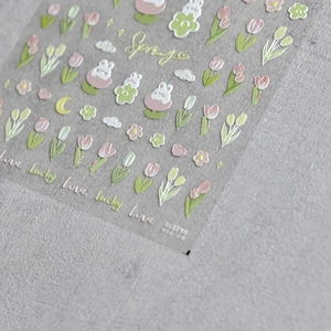 Detail shot of embossed tulip and bunny nail stickers with Spring themed patterns