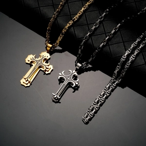 Detailed shot of double-layered cross pendants in gold and silver on black leather