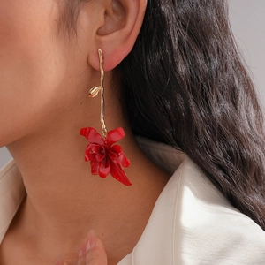 Artistic long drop flower earrings with gold branches and vibrant red orchid petals
