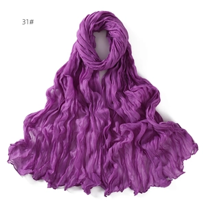 Macro view of purple linen cotton scarf featuring pleated texture and soft fabric detail