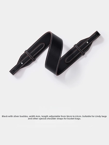 Detail of 4cm wide black lychee grain leather strap with silver adjustable buckles
