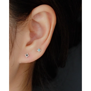 Sterling silver eight-pointed star stud earrings with black and turquoise stones