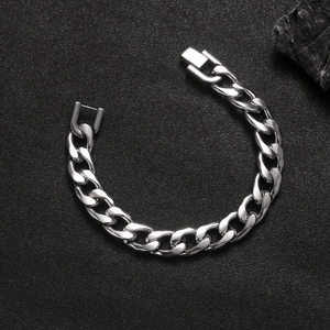 Detailed view of silver Cuban link bracelet with jewelry clasp on dark stone background