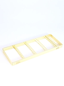 Detail of golden metal jewelry rack showing folding frame with earring holes and hooks