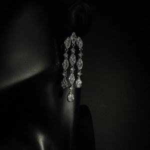 Elegant silver tassel earrings with marquise and teardrop cubic zirconia on dark background