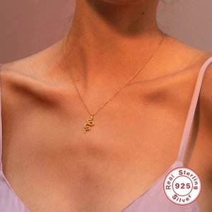 Golden S925 sterling silver snake pendant necklace with diamonds on a female model