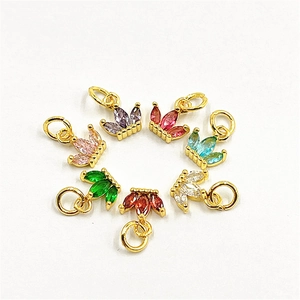 Detailed top view of crown-shaped copper pendants with colorful zircon inlays for DIY