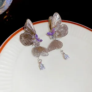 Elegant butterfly tassel earrings with purple crystals and silver needle studs