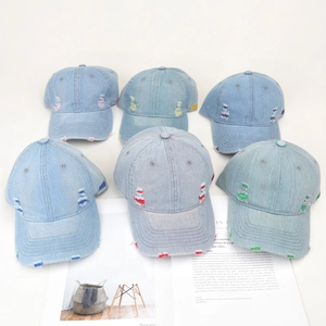 Set of vintage distressed denim baseball caps with colorful ripped holes and 1999 embroidery