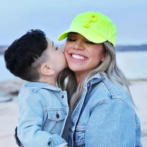 Fluorescent yellow baseball cap with P letter embroidery shown in a family outdoor setting