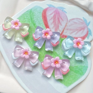 Translucent resin bow accessories with pink flowers in various pastel colors