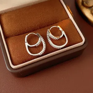 Minimalist silver double layered interlocking hoop earrings with cubic zirconia stones