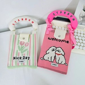 Cute knitted mini phone bags with tulip and cartoon dog patterns on white desk