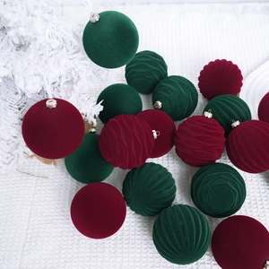 Flocked Christmas ball ornaments in burgundy and dark green with various textures