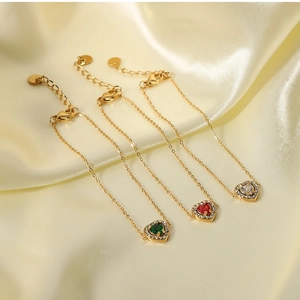 Detailed macro of gold-plated bracelets with heart-shaped zircon stones in three colors