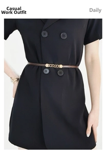 Detail of brown leather skinny belt with golden chain buckle on a dress for daily outfits