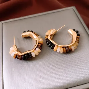 18K gold plated tiger eye beaded C-shaped hoop earrings on a vintage velvet background