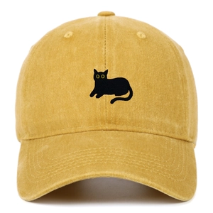 Close-up of black cat embroidery on yellow washed cotton baseball cap with textured finish