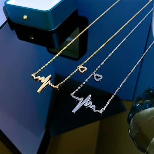 Minimalist heartbeat and heart pendant necklaces in gold and silver stainless steel