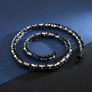 Detailed view of silver and black geometric link chain in polished stainless steel