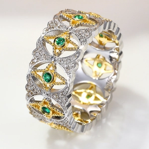 Macro view of vintage silver and gold ring with emerald green stone and star detail