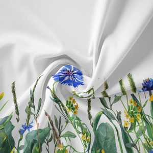 Close-up of bohemian floral tapestry fabric with blue cornflowers and soft textures