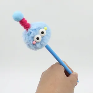 Close-up of blue fuzzy monster plush pen with large eyes and colorful antenna