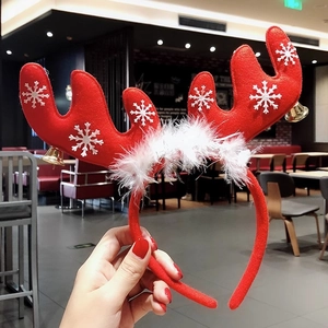 Red Christmas reindeer antler headband with white snowflakes and bells for festive decor