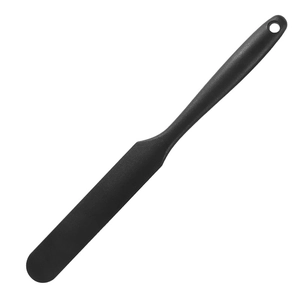 Detail view of a black narrow cake spatula with hanging hole for professional baking