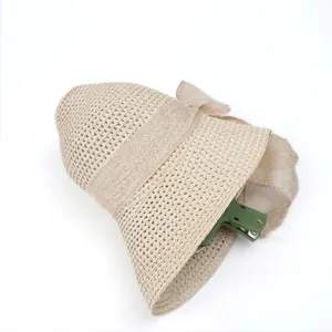 Foldable beige straw sun hat with elegant hollow weave design for summer beach travel