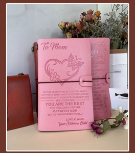 Detail view of embossed leather A6 notebooks in pink and brown with heartfelt engravings