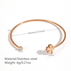 Rose gold stainless steel open bangle featuring a clover charm and small sparkling crystal