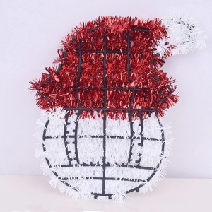 Detail view of a Christmas hat ornament made from red and white tinsel on a metal frame