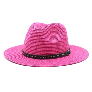 Detail of fuchsia Fedora straw hat with black leather band and golden metallic studs
