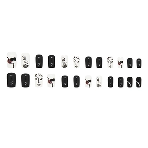 Black and white press-on nails set with abstract face lines and geometric patterns