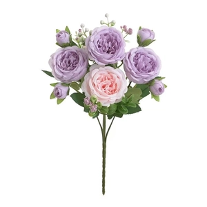 Close-up of purple and pink artificial roses with realistic green leaves on white background