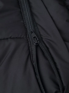 Macro shot of durable metal zipper and windproof fabric on black oversized hooded jacket