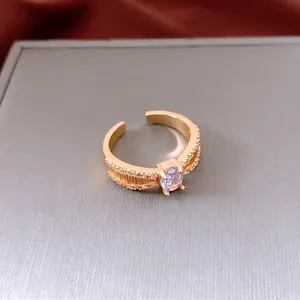 Vintage gold adjustable ring with a purple oval stone and sparkling side zircons