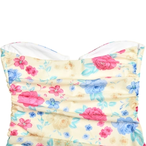 Detail of floral strapless top featuring pink rose print and yellow ruched fabric