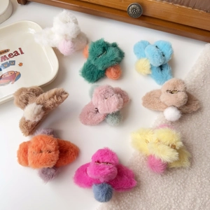 Colorful plush hair claws with pompom details and metal spring in nine assorted colors