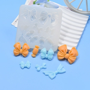 Detailed view of various bow and candy silicone molds for fondant and craft resin